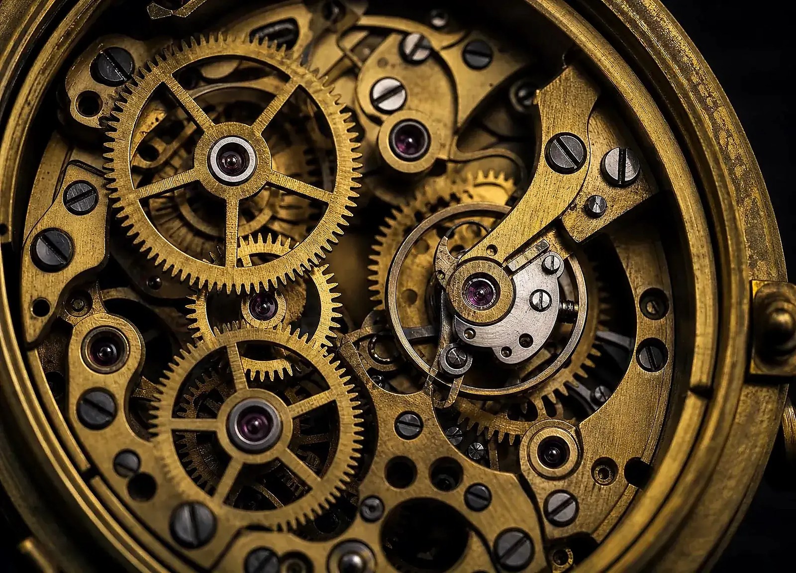 Macro detail of the brass gear train inside an antique clock movement